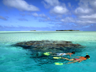 Image of two adventures guests snorkelling the beautiful Aitutaki Lagoon to experience what it has to offer