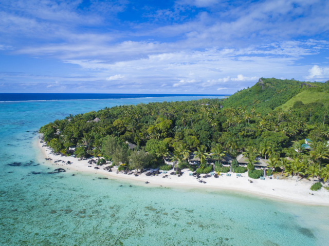 A stunning aerial image of the Ultimate Beachfront Bungalows and Villa categories, capturing a breath-taking view of the various shades of the blue lagoon