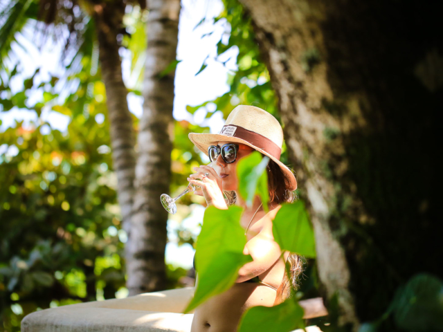 A resort guest enjoying a chilled glass of champagne on a private deck