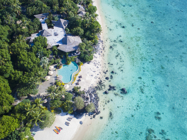 A stunning aerial image of the resort and the breath-taking lagoon showing variety shades of blue