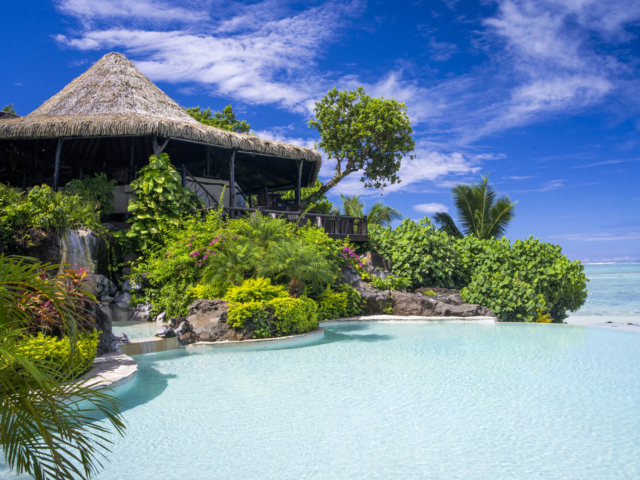 A clear image of the Rapae Restaurant overlooking the swimming pool, fountain surrounded by lush garden