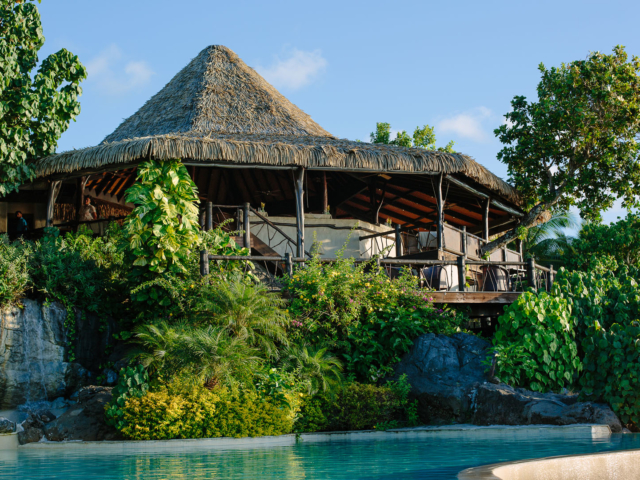 A lovely close side view of the Rapae Restaurant perched on solid volcanic rocks amidst tropical lush garden