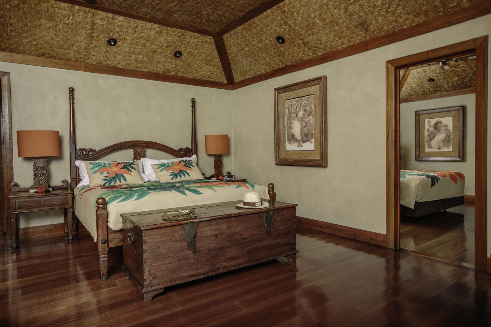 A beautiful view of the Premium Beachfront Bungalow one-bedroom featuring the various art designs on the head-bed, lamps and pictures on the wall