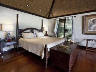 A close up view of the Ultimate Beachfront Bungalow bedroom set up featuring special gifts for check-in guests