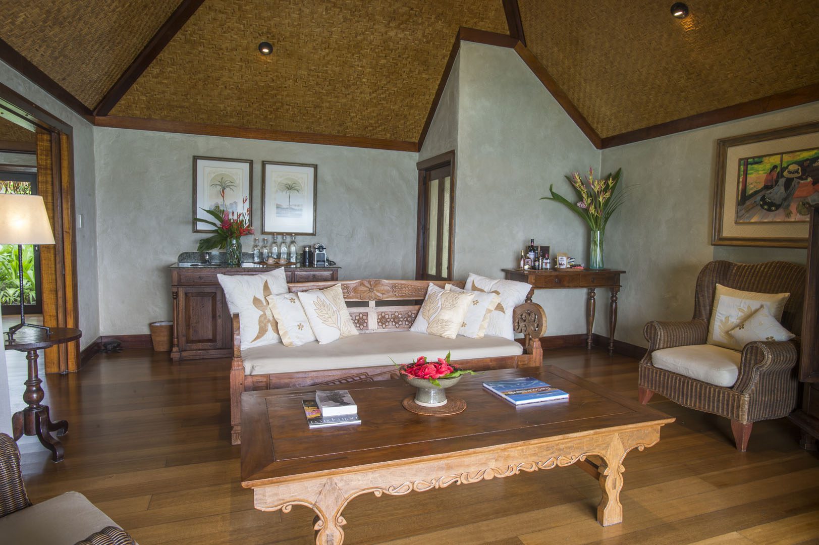 A view of the Ultimate Beachfront Villa Living room showcasing the traditional wood carvings on lounges and interior décor