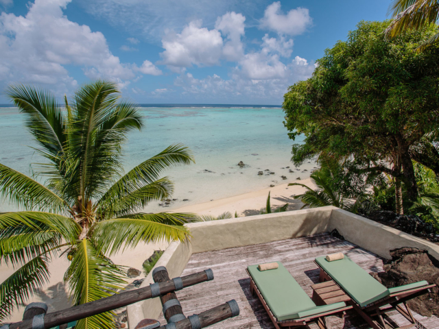 View of the large Ultimate Beachfront Villa Deck area with loungers perfectly set up to face the stunning lagoon view