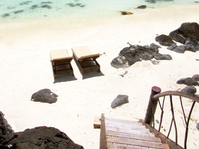 Ultimate Beachfront Villa view of the decking leading down to stairs directly onto the beach and lagoon