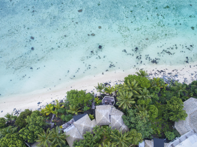 Aerial view of the blue lagoon and tropical green gardens