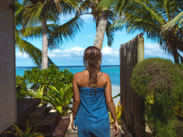 Guest walking back to their beachfront bungalow from the beach after a swim