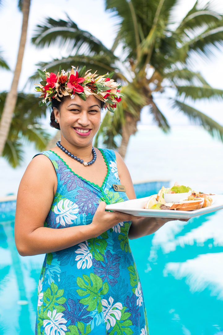 Friendly Waitress serving a tropical platter overlooking our infinity pool