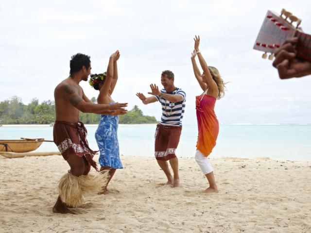 Beach Hut Attendants performing dance lessons with resort guests on the beach