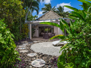 View of the Premium Garden Villa from the Garden featuring the balcony and front yard privately surrounded by lush garden