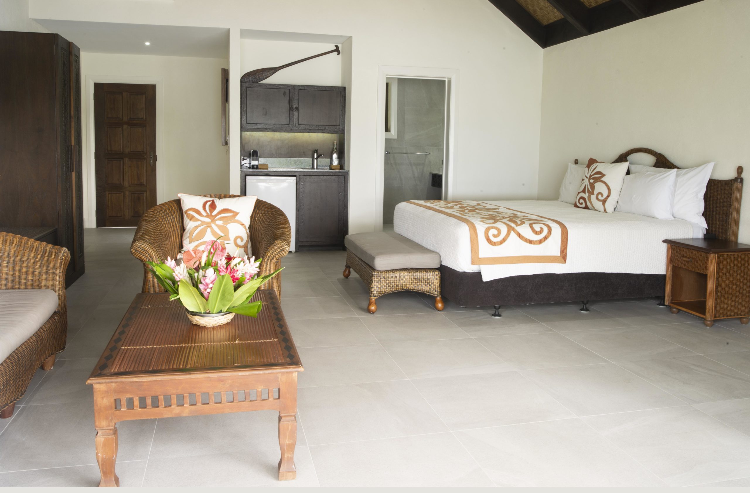 Premium Beachfront Suite showcasing the comfortable super king sized bed and spacious open-plan layout that allows the cool sea breeze to sway in