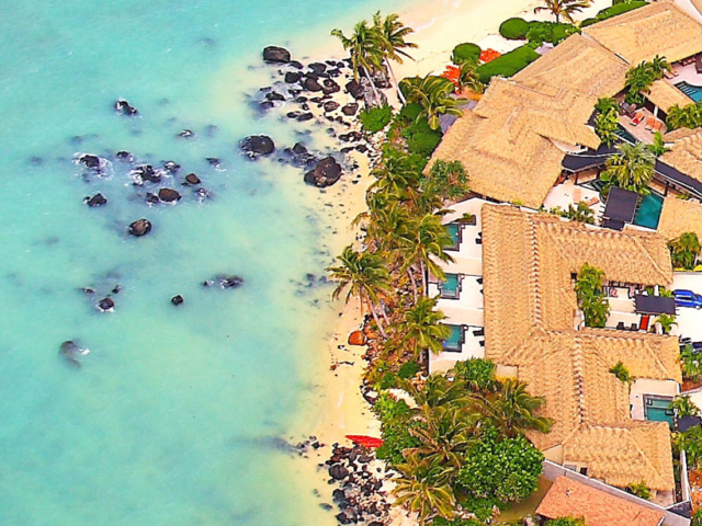 Aerial view of Te manava and it's stunning beachfront location surrounded by tropical greenery