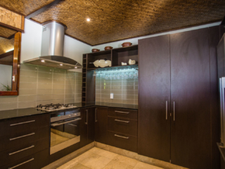 Modern dark stained Presidential Beachfront Villa Kitchen