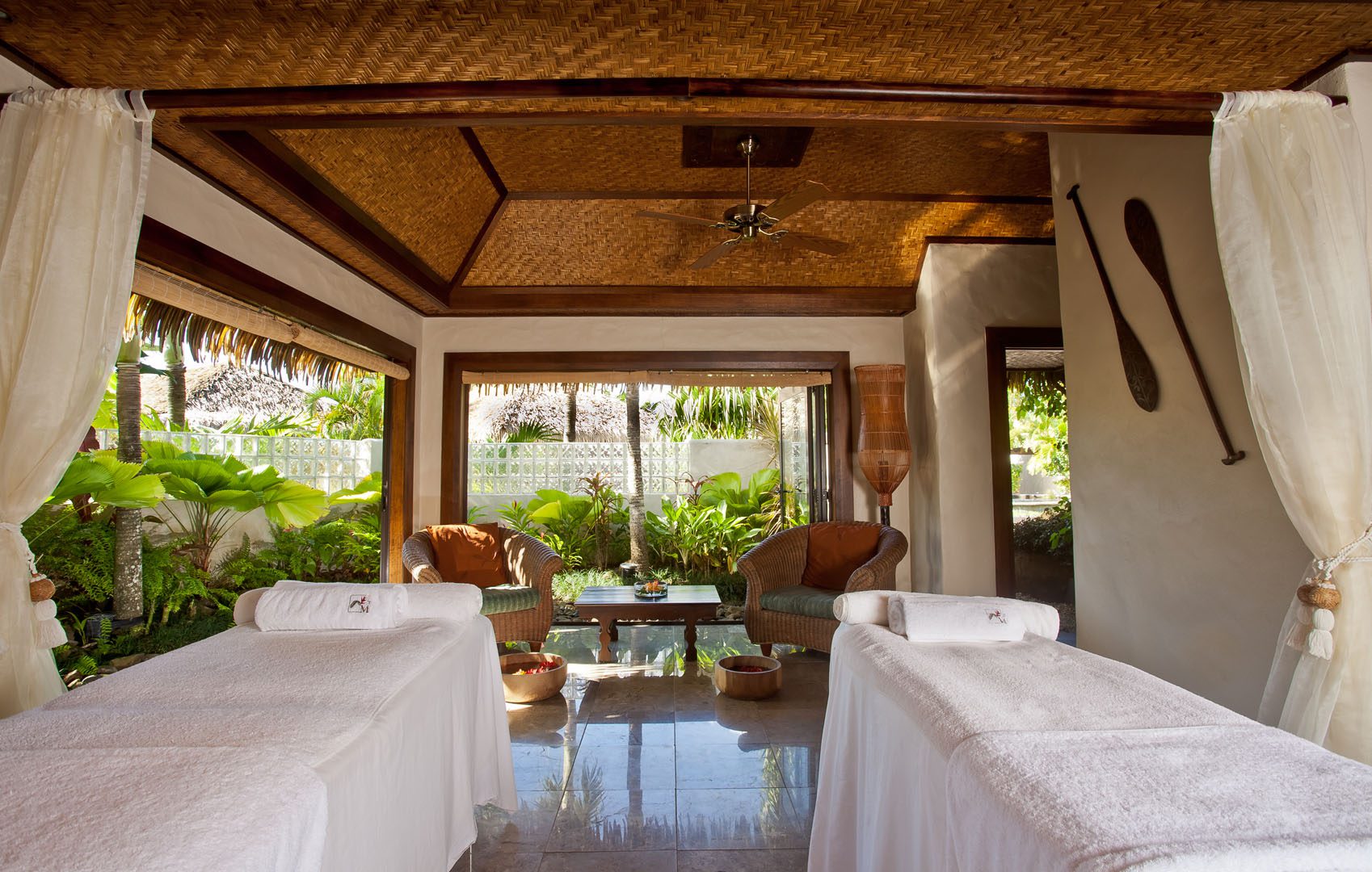 Luxurious spa with Polynesian inspired decor, looking out to the lush tropical gardens