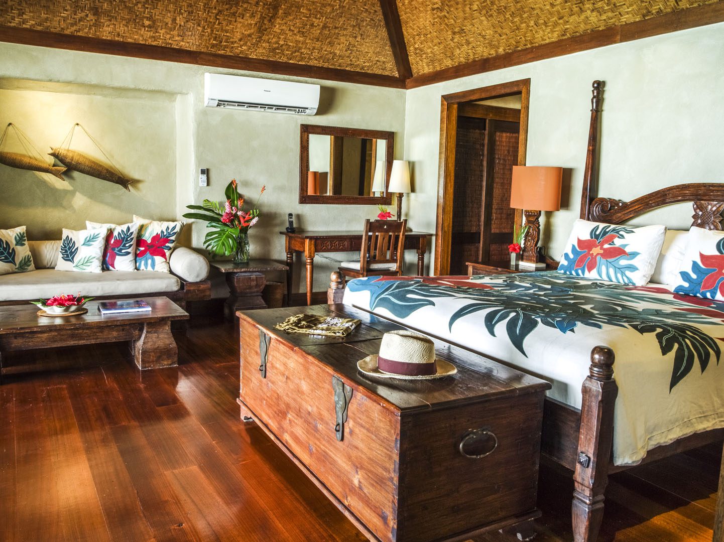 A side view of the Premium Beachfront Bungalow bedroom showcasing the matching tropical design printed on the linen, pillow cases  and cushion covers