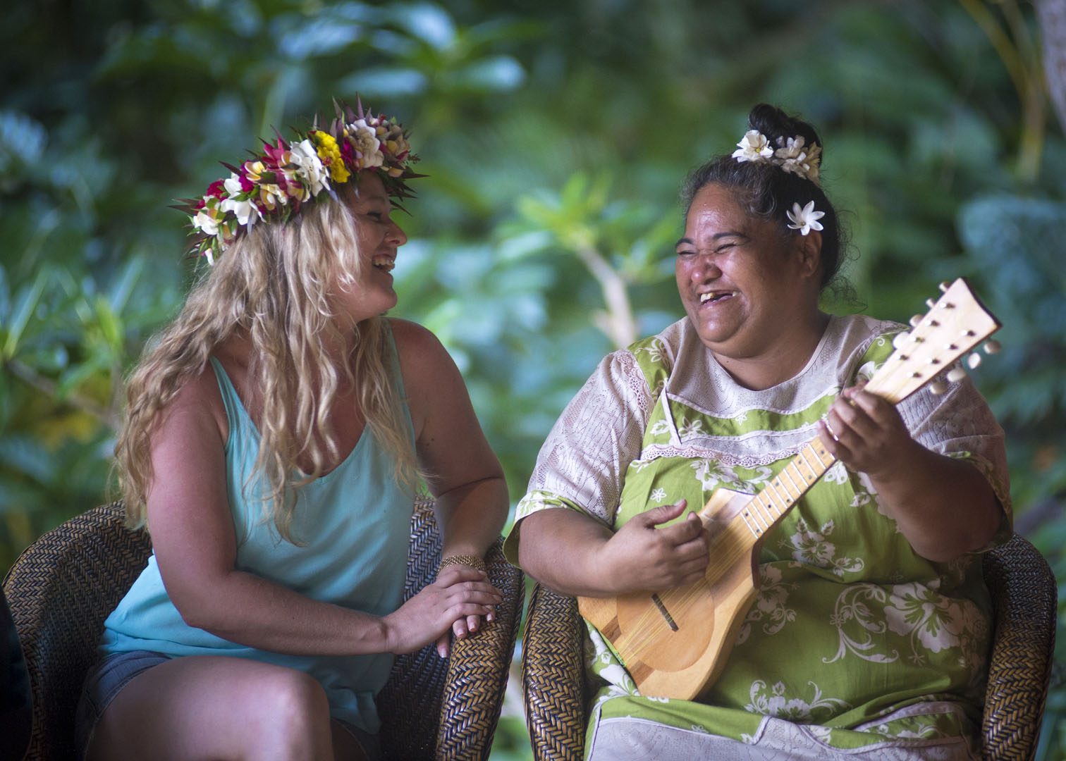 A friendly image of a resort guest enjoying the entertainment performed  solo by a dedicated staff, playing ukulele