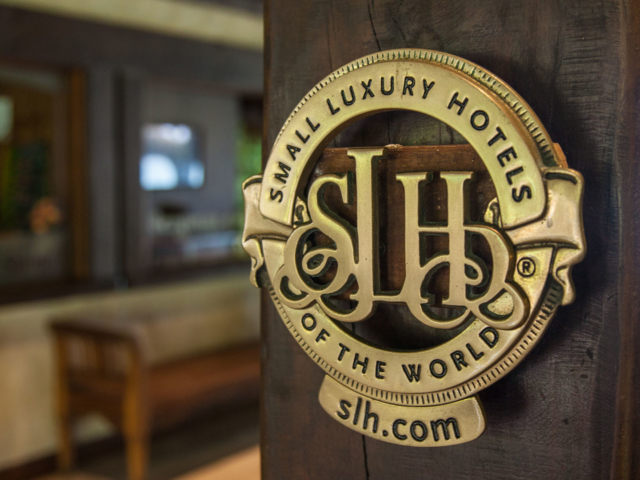Small Luxury Hotels of the World Signage adhered to the wall on the Resort’s main entrance for recognition