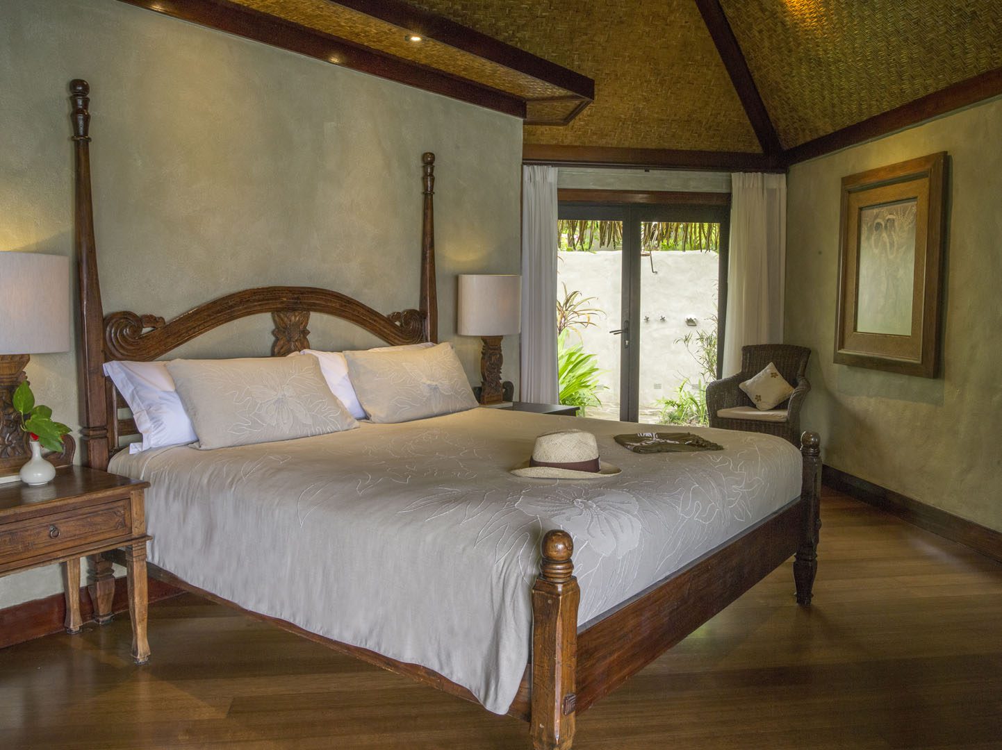 A beautiful set up of the Ultimate Beachfront Villa bedroom with a special his and hers gift placed on the bed