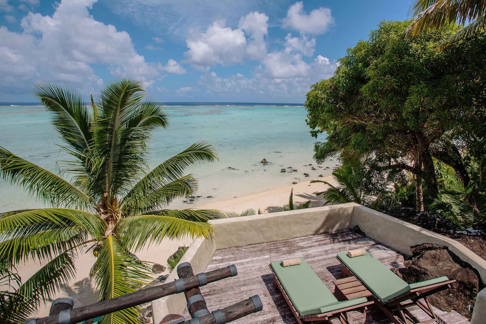 View of the large Ultimate Beachfront Villa Deck area with loungers perfectly set up to face the stunning lagoon view