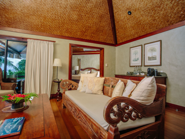 interior of the Ultimate Beachfront Villa Living area with Polynesian decor with modern wooden stained floors and trimmings