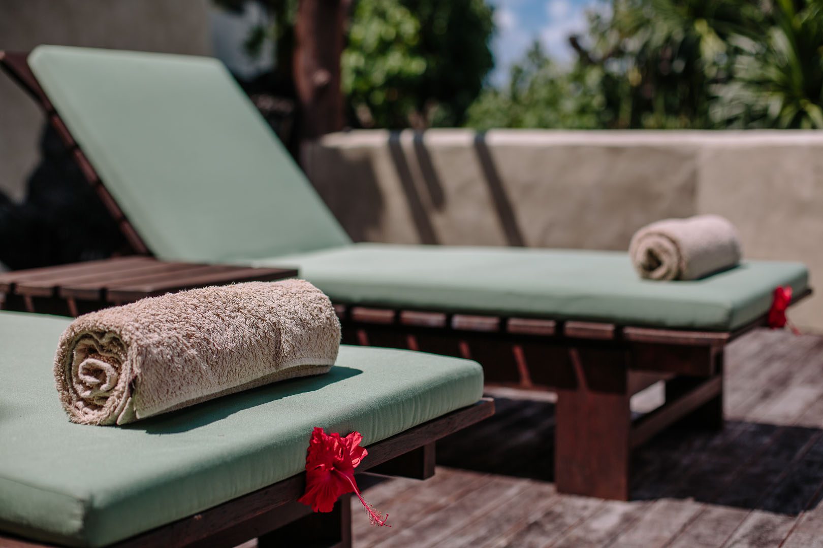 Sun Loungers with tropical flowers and fresh towels laid out in front of the Ultimate Beachfront Villa