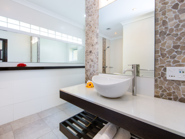 Image of the Premium Family Room spacious Bathroom featuring a clear vanity decorated with flowers