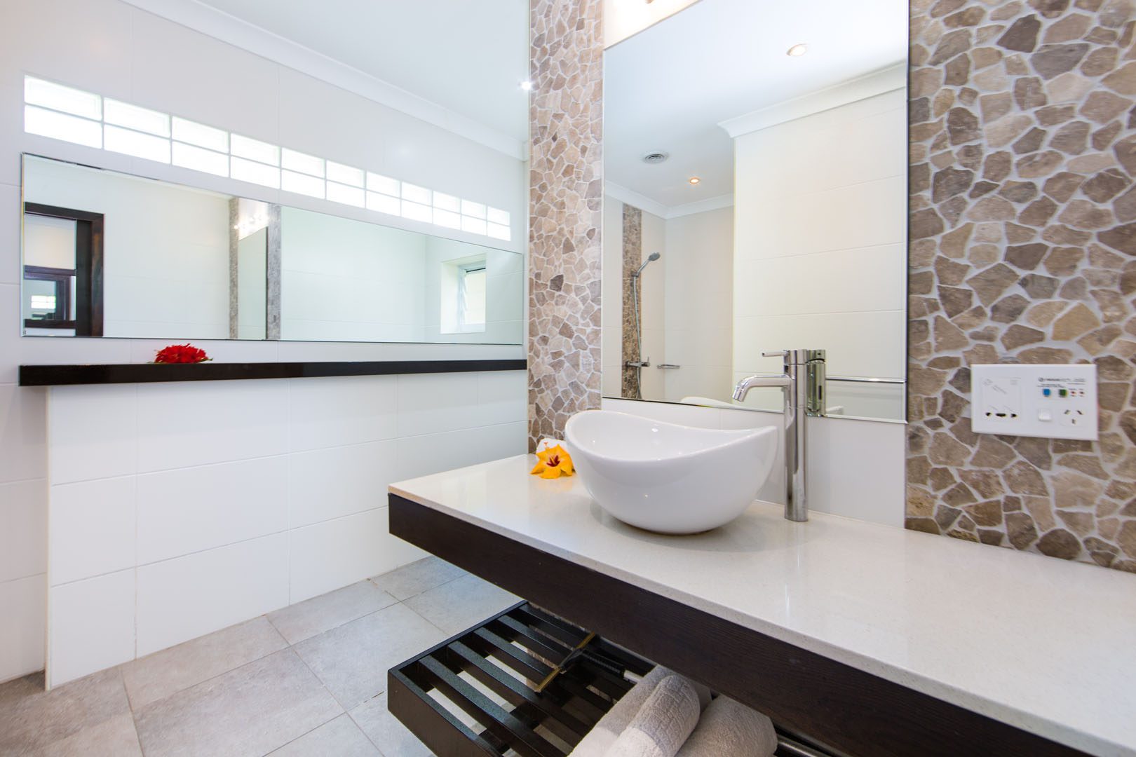 Image of the Premium Family Room spacious Bathroom featuring a clear vanity decorated with flowers