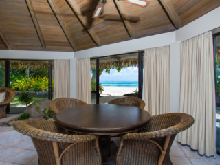 Interior image of the Premium Beachfront Villa showcasing the dinning area with a clear beachview background