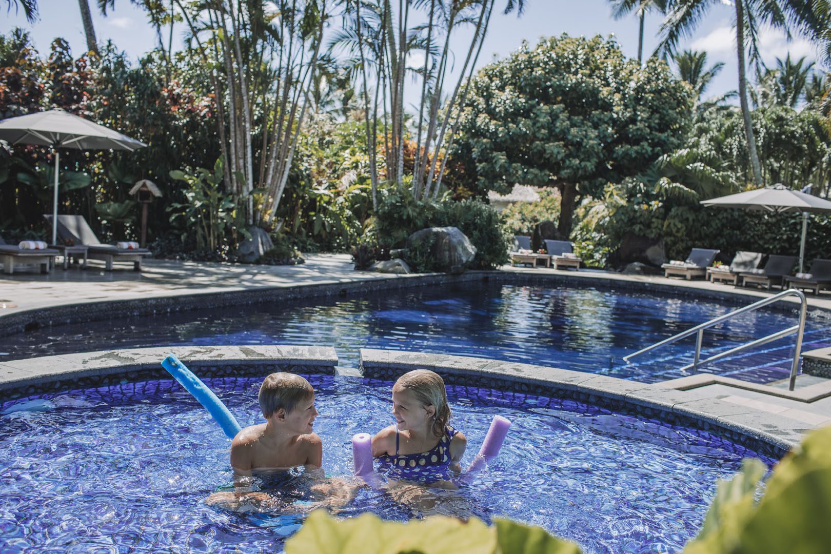 Children enjoying their splash pool set aside from the adults swimming pool
