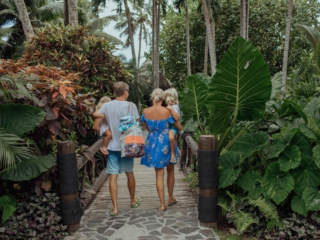 Family walking through the tropical grounds at Pacific Resort Rarotonga