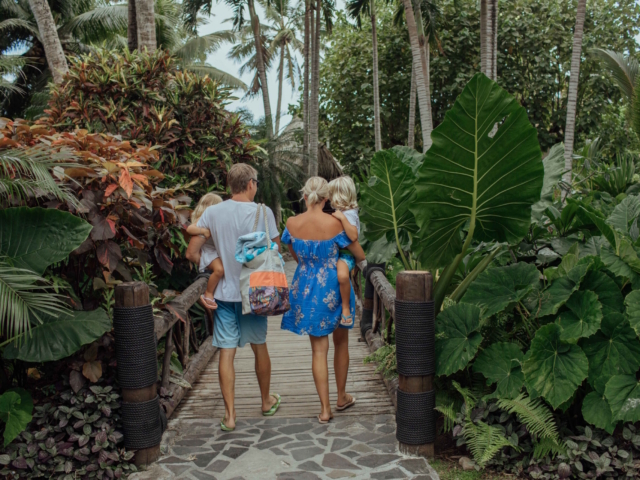 Family walking through the tropical grounds at Pacific Resort Rarotonga