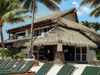 Beach loungers and beach hut overlooking Muri Lagoon at Pacific Resort Rarotonga