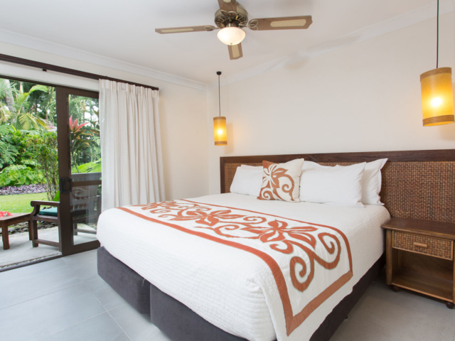 Image of the Super King-sized bed in the Standard Family Room showcasing a beautiful garden view outside the balcony
