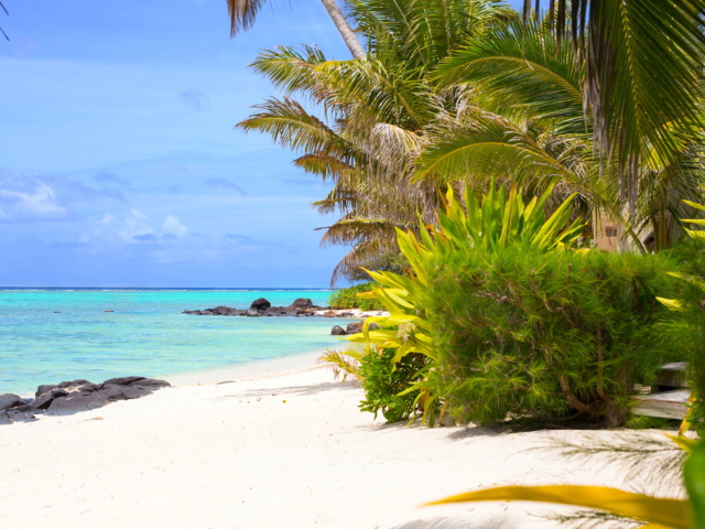 View of the beautiful white sandy beach and blue lagoon located in front of Te Manava