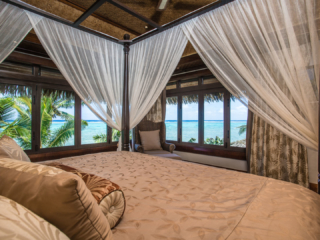 View of the elegant Presidential Beachfront Villa Bedroom overlooking the lagoon view