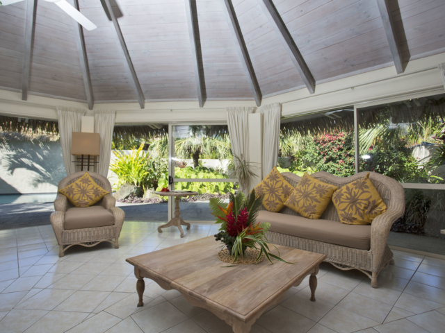 Standard Pool Villa Interior view of the elegant open living area with sliding doors leading out to the pool & garden area