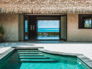 View of the Ultimate Beachfront Villa highlighting the private pool and open plan living area leading onto the deck that showcases the blue lagoon view