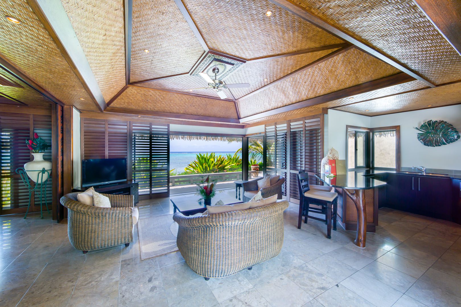 Te Manava Luxury Villas & spa Ultimate beachfront villa view from the inside the lounge & modern kitchen with a Polynesian décor