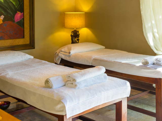 View inside te manava spa, with a welcoming ambient set up with massage tables and Polynesian artwork displayed