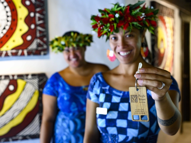 Guest Service Attendants showcasing a standard guest-room-key, ready for guest check-in