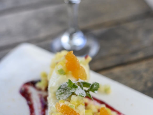 A mouth-watering dessert platter served with a glass of white wine