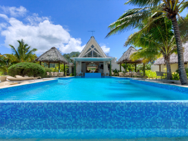 A beautiful reverse view from the beach of infinity pool and resort restaurant setting