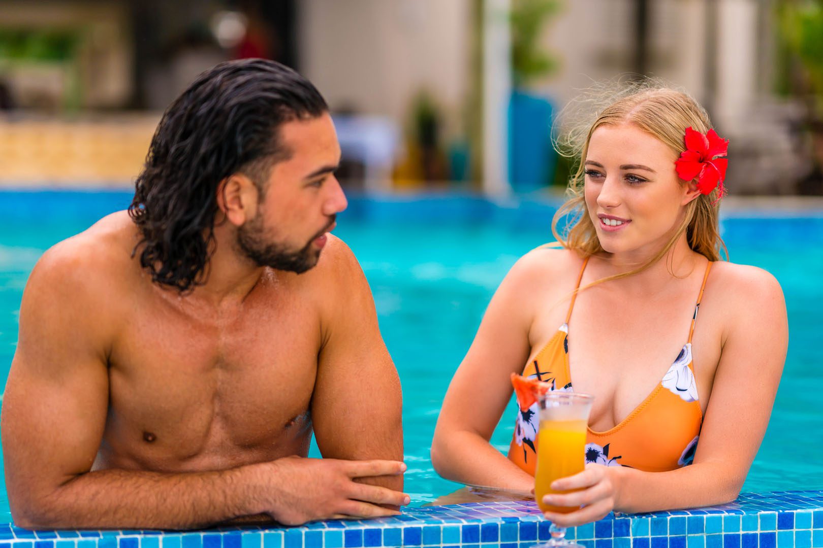 A couple enjoying a cocktail in the pool